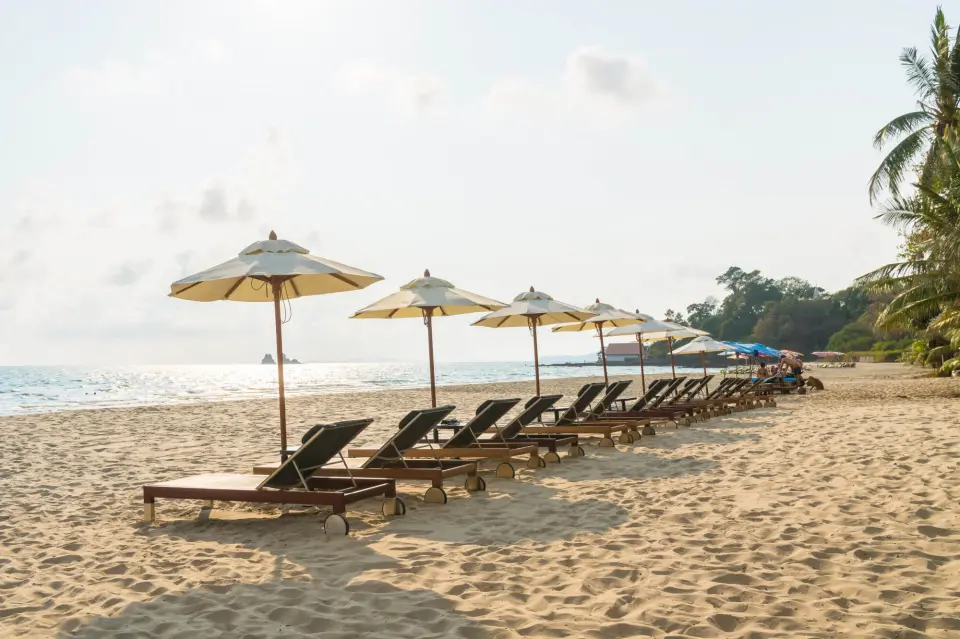 Beautiful goa beach with umbrella and chair on blue sky