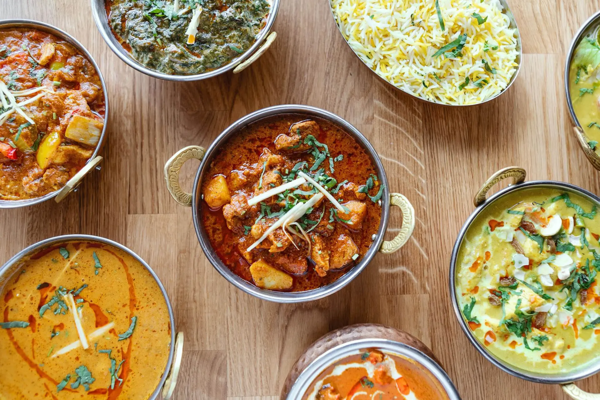 Different indian food on wooden table